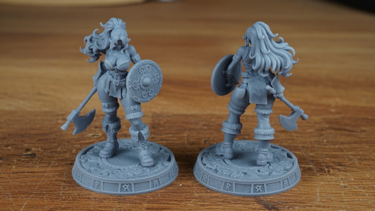 Unpainted grey resin Odin Daughter 4 miniatures showing front and rear views of the shieldmaiden figure