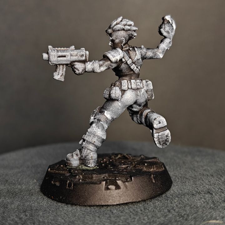 Female grenadier miniature mid-stride with submachine gun extended, rear three-quarter view showing back armour and belt pouches