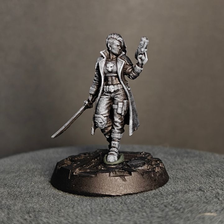 Three-quarter view of Street Cats gang leader in long coat holding pistol aloft, sword low, industrial resin base