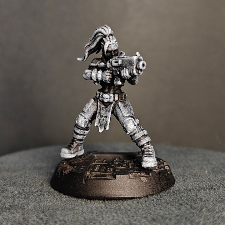 Female gang fighter standing wide, aiming pistol forward, long wild hair and skull belt token detail