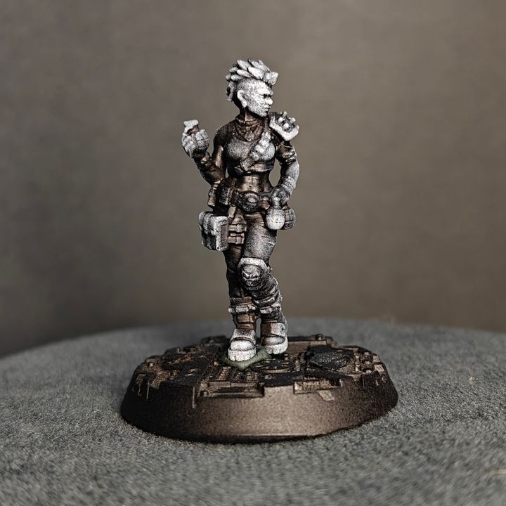 Female grenadier miniature with spiked hair, holding grenades in both hands, front view on urban base