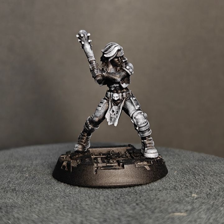 Gang fighter raising a spiked knuckle weapon overhead in rallying pose, skull loin cloth detail visible