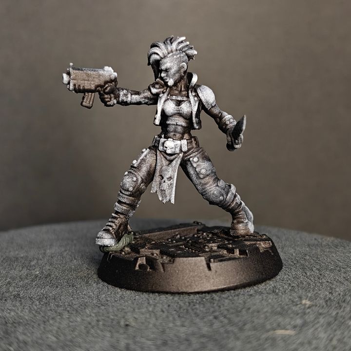 Female gang fighter striding forward with pistol extended, mohawk hair and studded shoulder armour