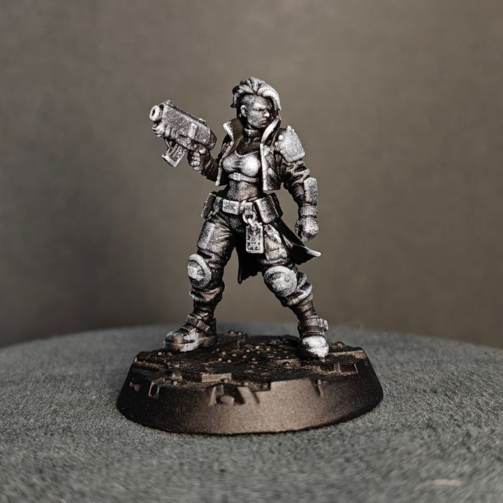 Gang fighter in guard stance holding pistol at hip level, close cropped hair and layered armour coat rear angle