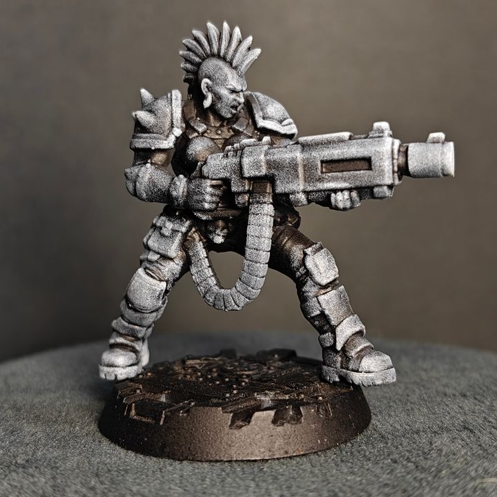 Heavy Gunner miniature rear three-quarter view showing coiled ammo feed, back armour detail and textured base
