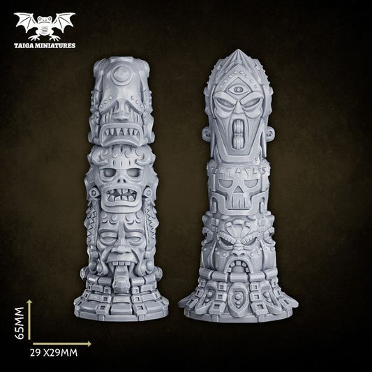 WarpLand miniature set of two resin totems covered in stacked skull carvings, grimacing faces, and occult geometric engravings, each standing 65mm tall on a 29x29mm base, shown unpainted in grey resin from front and back angles