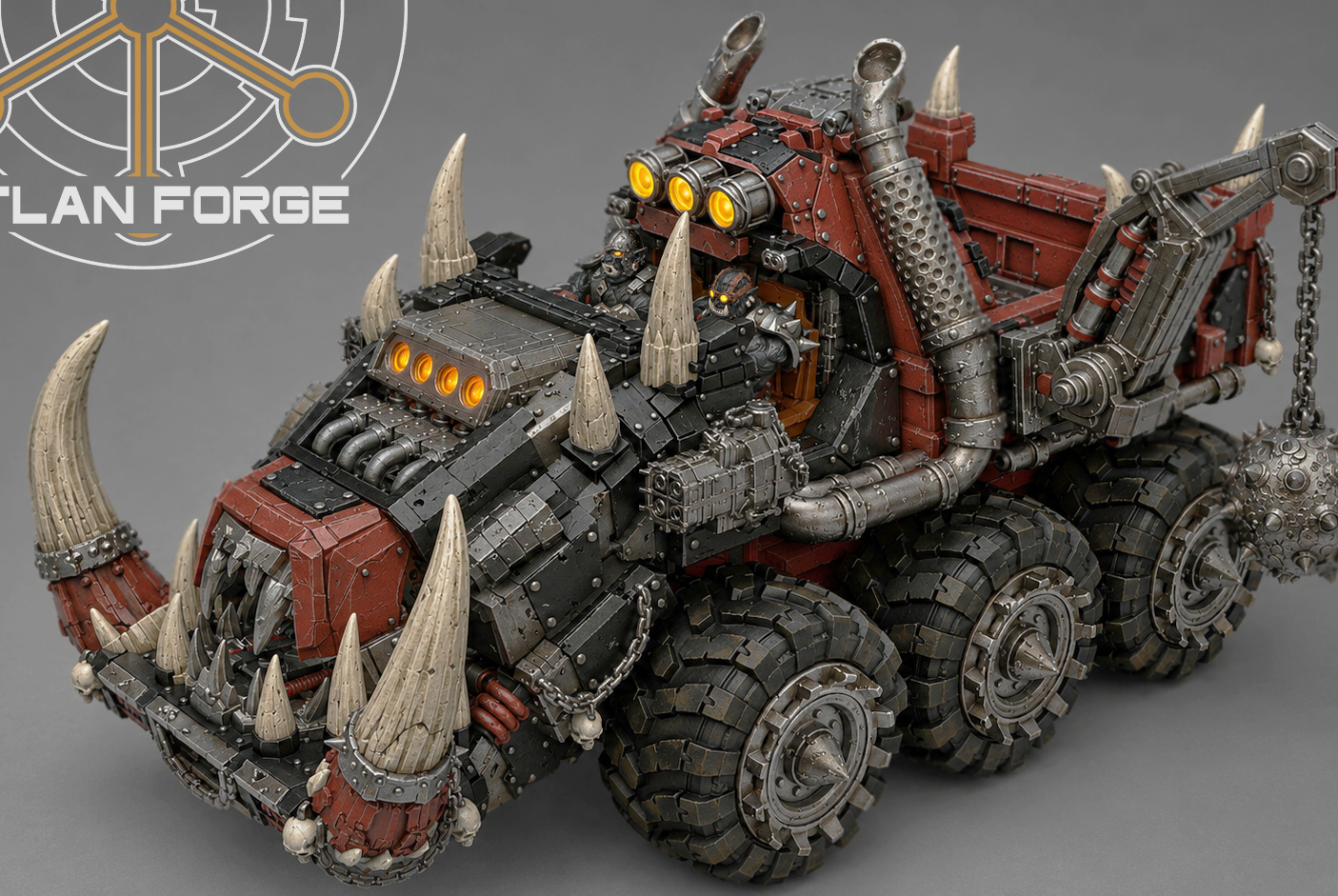 Elevated side view of painted Tuskhauler highlighting oversized tires, tusked jaw, and driver cabin.