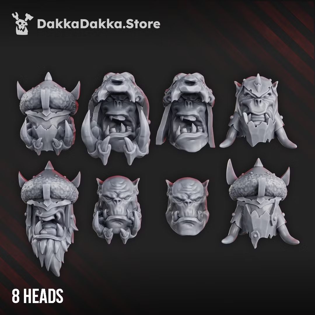 Eight greenskin head options from the Build Kit, showing helmeted and bare-headed variants with tusks